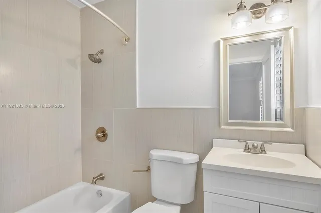 a bathroom with a sink toilet and tub