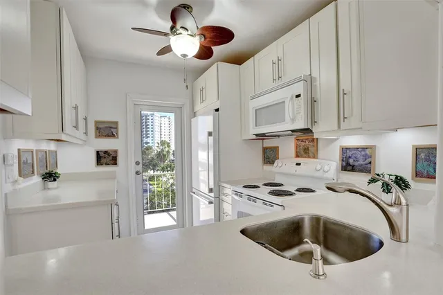 a living room with furniture and floor to ceiling windows