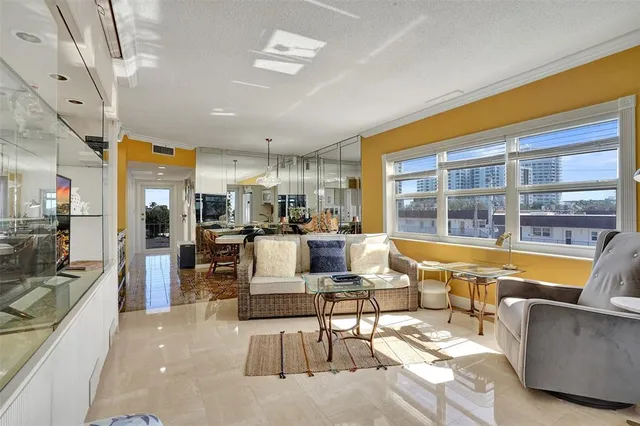 a living room with furniture and a floor to ceiling window