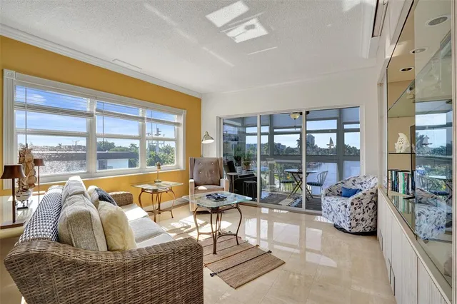 a living room with a table and a potted plant