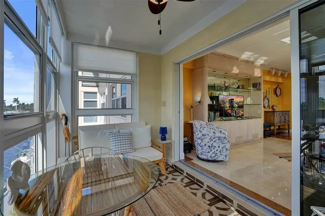 a living room with furniture a fireplace and a large window