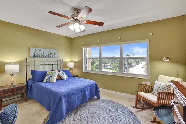 a bedroom with a bed and a lamp on the dresser