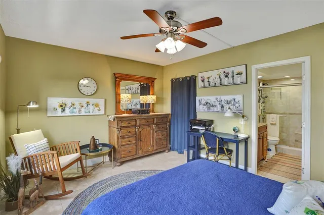 a bedroom with bed and a chandelier
