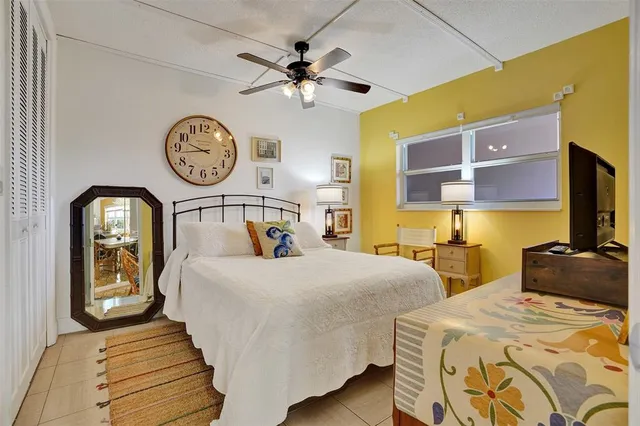 a living room with furniture a flat screen tv and a large window