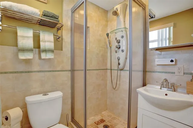 a dining room with furniture and a floor to ceiling window