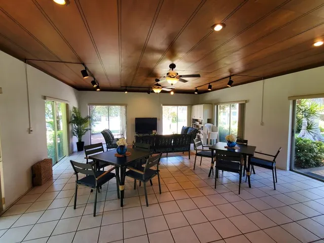 a swimming pool with outdoor seating and yard