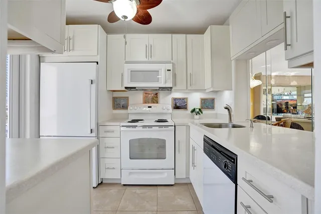a kitchen with cabinets stainless steel appliances and wooden floor
