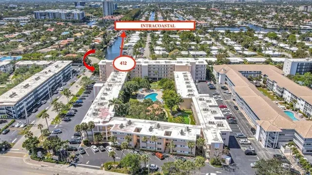 a kitchen with stainless steel appliances granite countertop a sink a stove and white cabinets with wooden floor