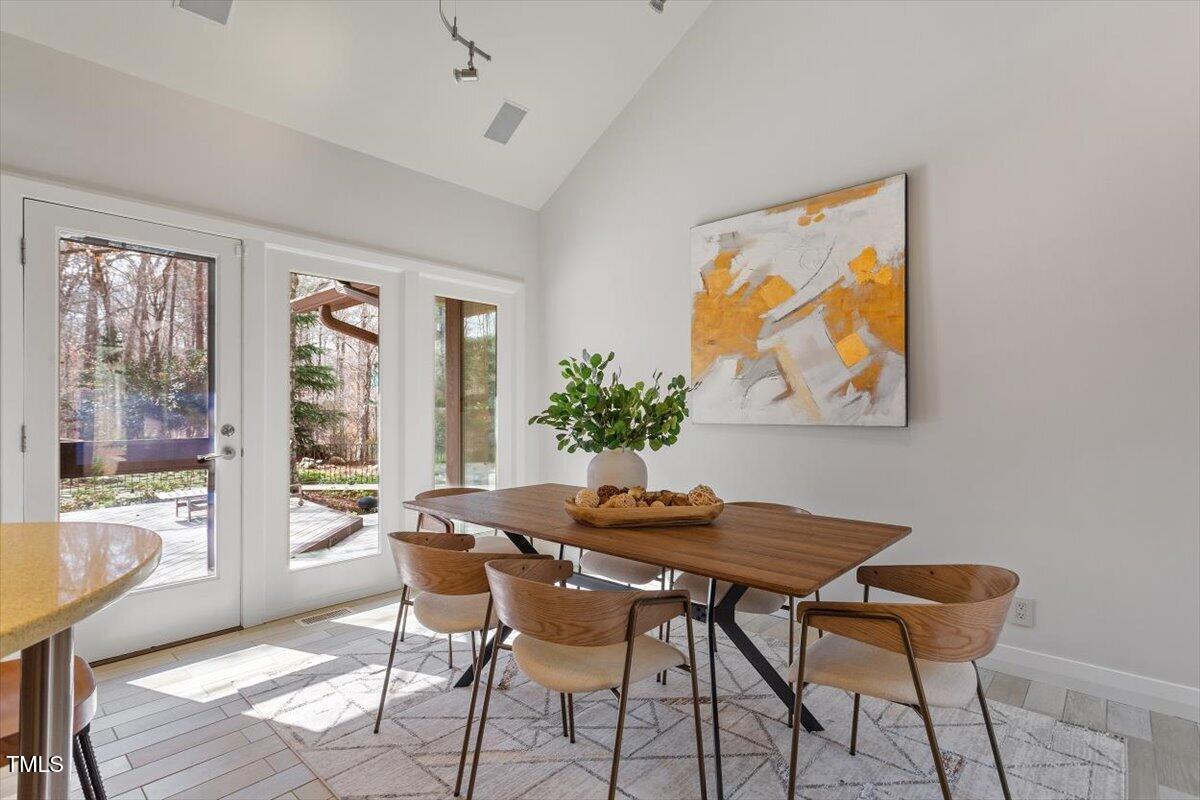 10729 Trego Trail Raleigh, NC 27614 - Photo 22 of 65 The Sun Filled Breakfast Room offers Tile Flooring, Vaulted Ceiling and Direct Access to the Deck