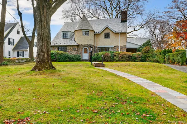 a front view of house with yard and swimming pool
