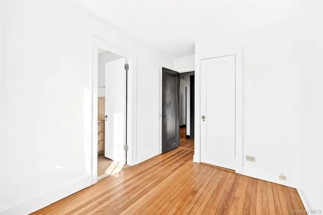 a view of hallway with wooden floor