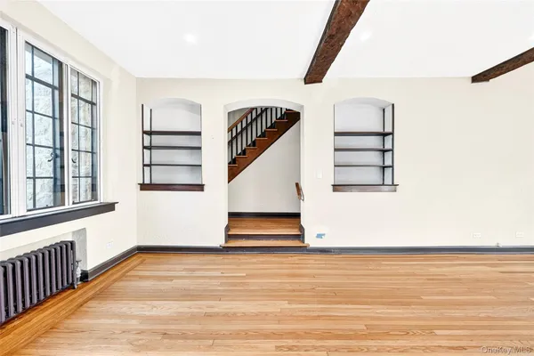 a view of entryway and hall with wooden floor