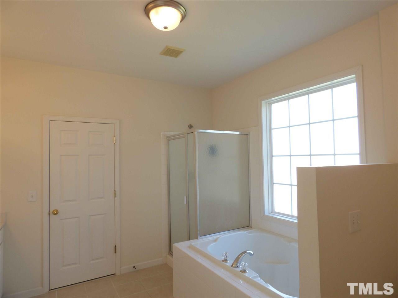 110 North Fields Circle Chapel Hill, NC 27516 - Photo 14 of 24 a bathroom with a tub a window and a shower