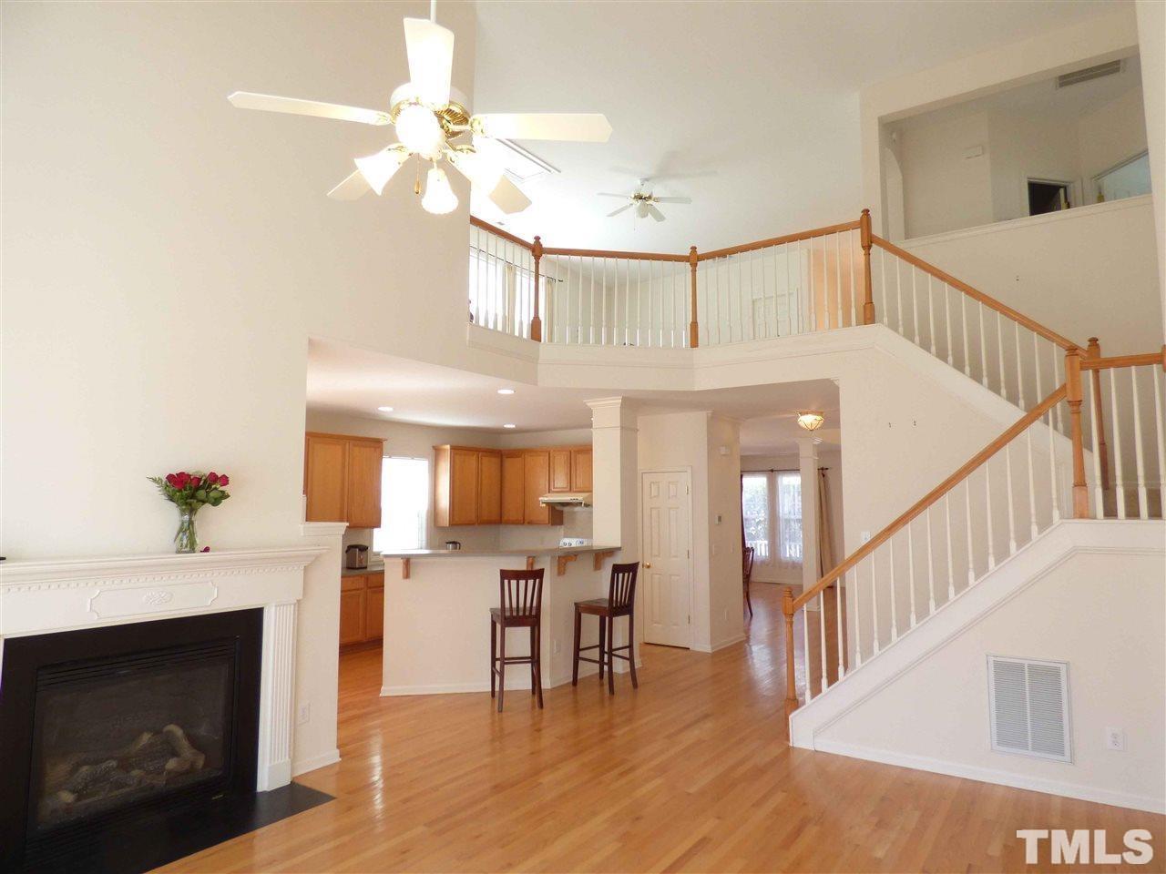 110 North Fields Circle Chapel Hill, NC 27516 - Photo 9 of 24 a view of a livingroom with furniture a fireplace wooden floor and staircase