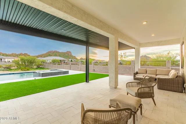 a bedroom with a bed a couch and a chandelier