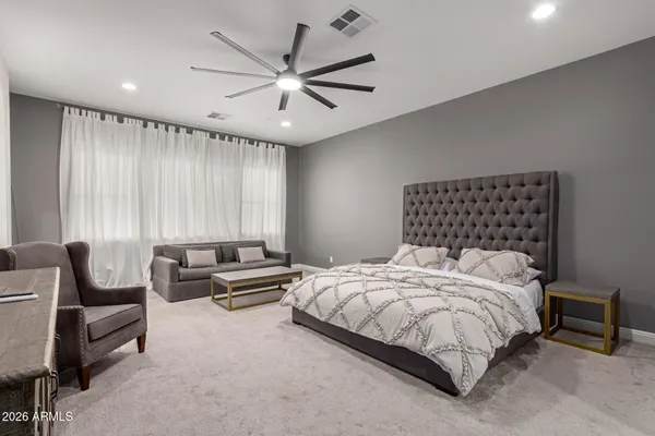 a bedroom with a bed next to a window