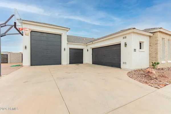 a kitchen with stainless steel appliances granite countertop a stove a sink a microwave a refrigerator and white cabinets