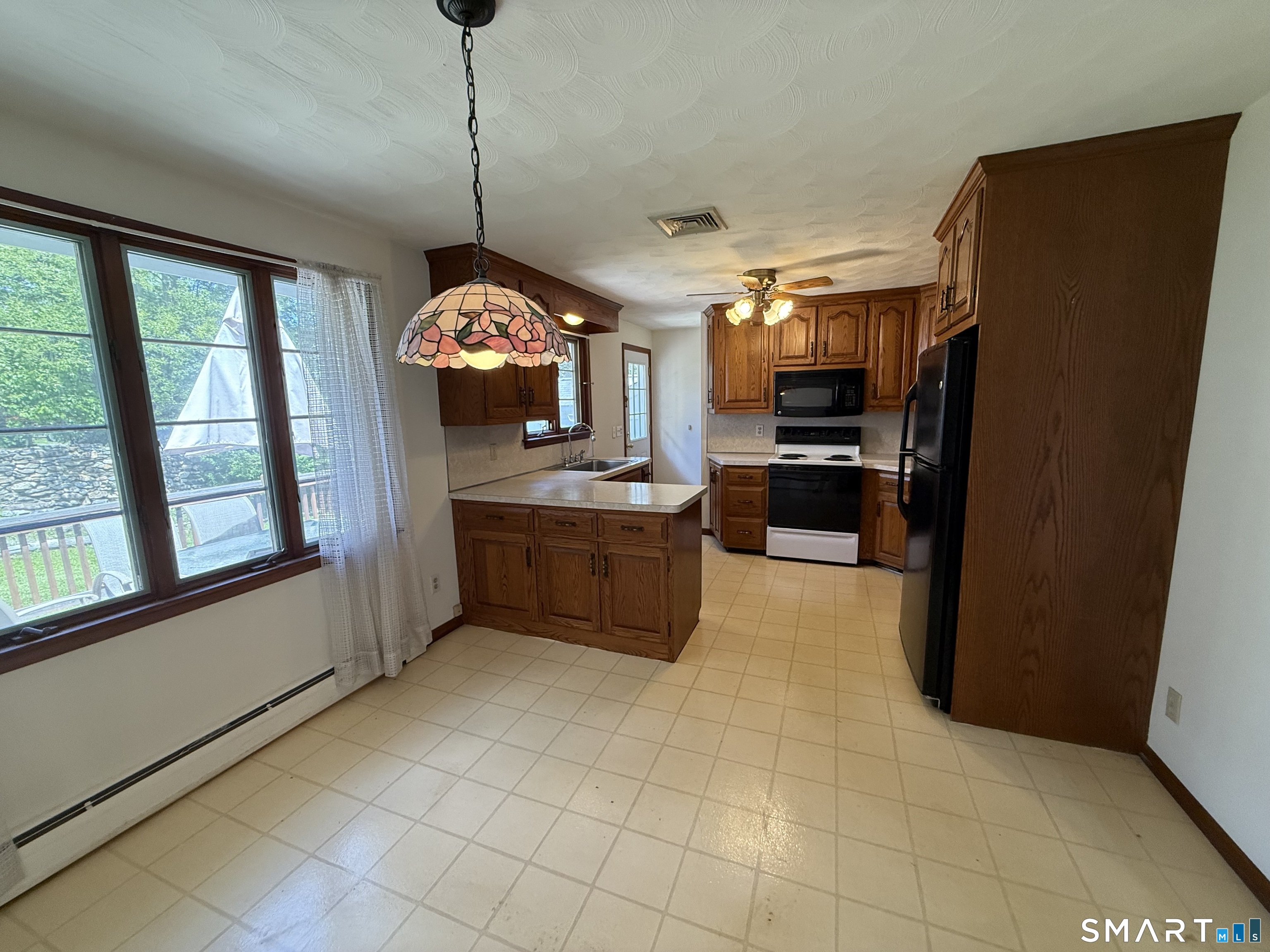 26 Maple Street Trumbull, CT 06611 - Photo 16 of 37 a kitchen with stainless steel appliances granite countertop a refrigerator a sink and a stove