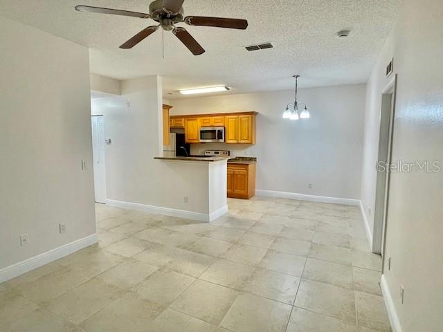 717 Secret Harbor Lane, Unit 309 Lake Mary, FL 32746 - Photo 11 of 20 a view of a kitchen with a sink and a refrigerator