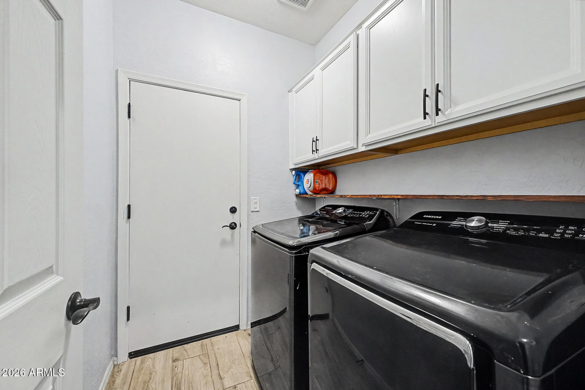 16719 West Rowel Road Surprise, AZ 85387 - Photo 23 of 28 a close view of a stove and utility room with washer and dryer