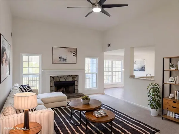 a living room with furniture fireplace and window