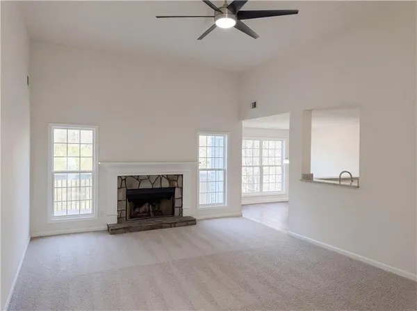 a view of a livingroom with a fireplace window and fireplace