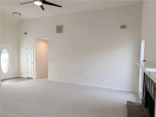 a view of empty room with ceiling fan