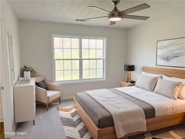 a bedroom with a bed couch and a window