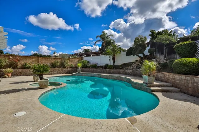 a view of a house with swimming pool and a yard
