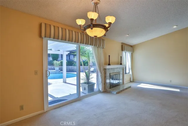 a view of an empty room with a fireplace and a large window