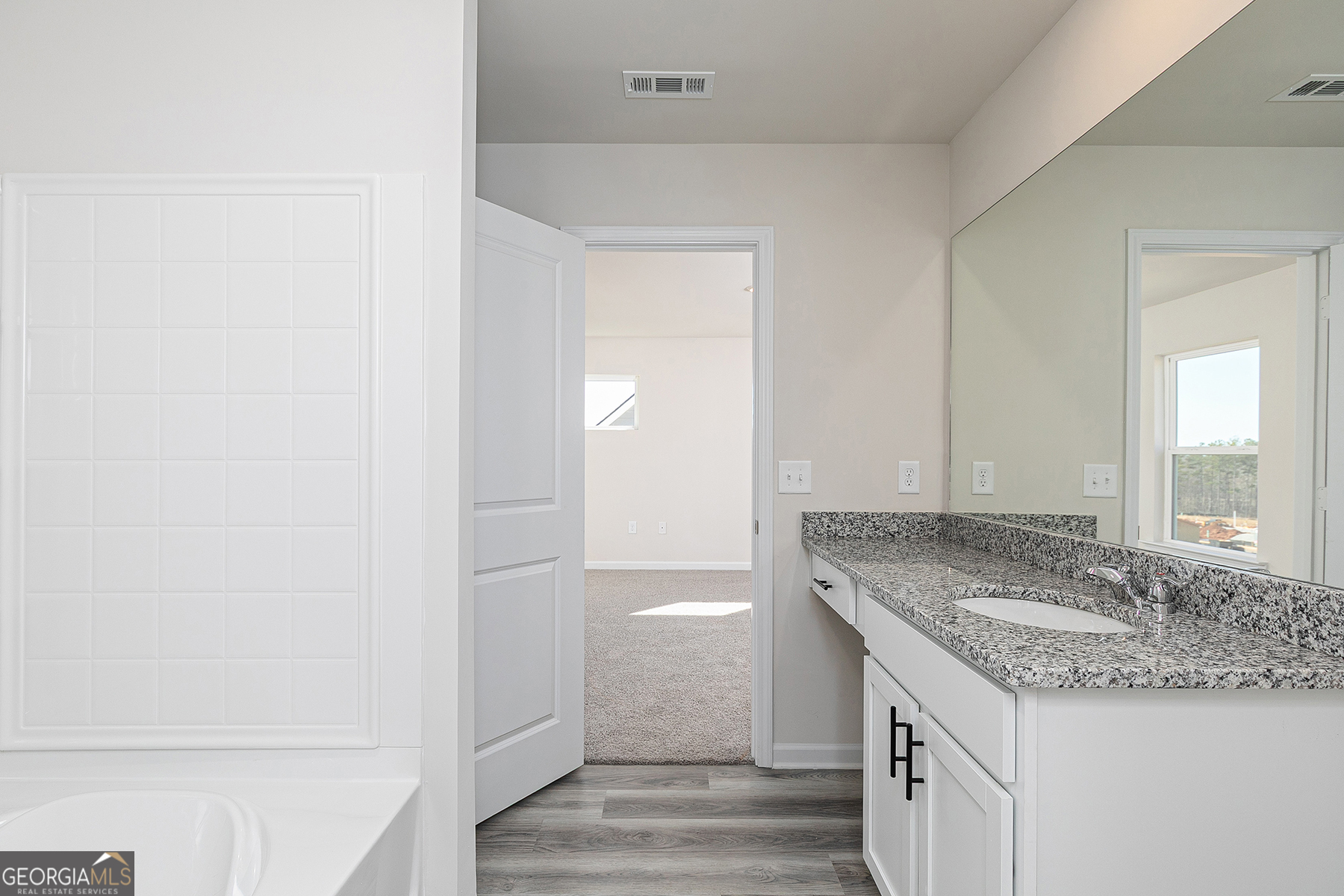 642 Mackenzie Cove Villa Rica, GA 30180 - Photo 14 of 17 a bathroom with a granite countertop sink and a mirror