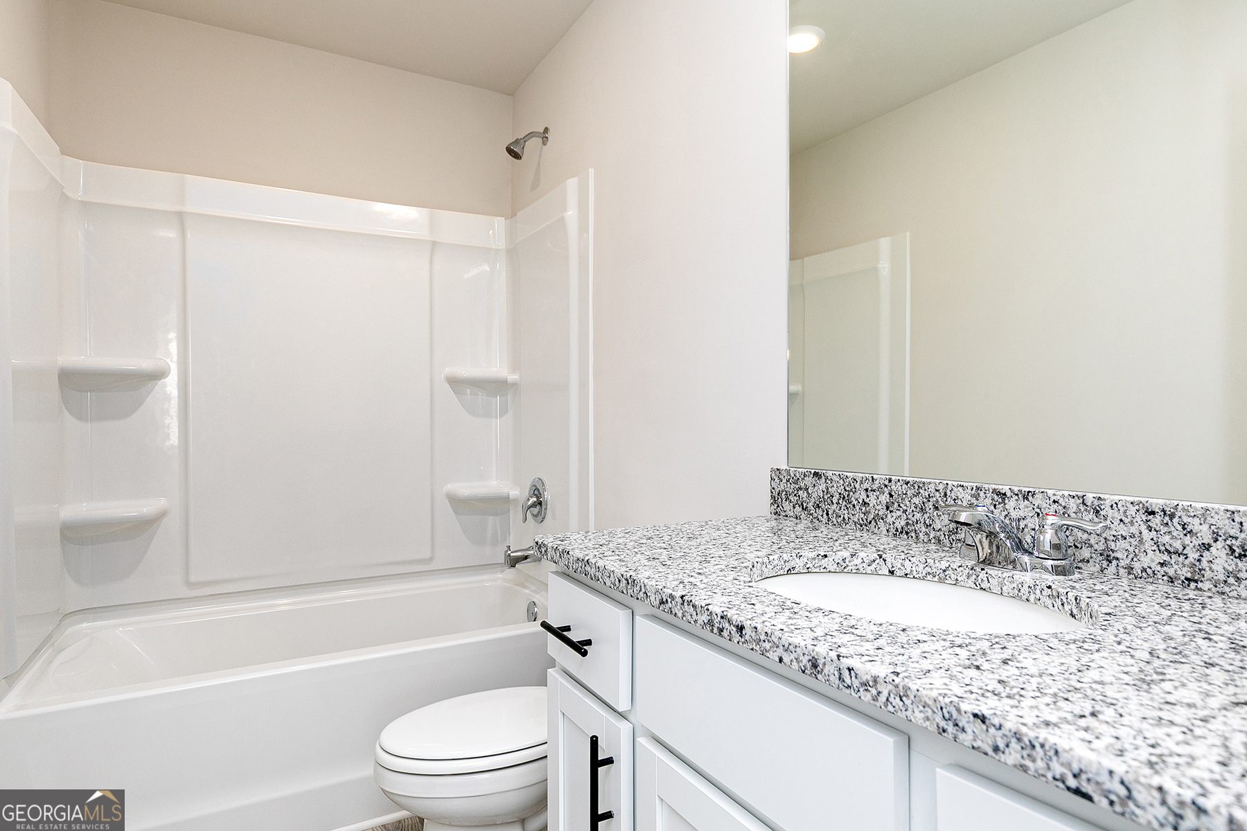 642 Mackenzie Cove Villa Rica, GA 30180 - Photo 17 of 17 a bathroom with a granite countertop sink a toilet and shower