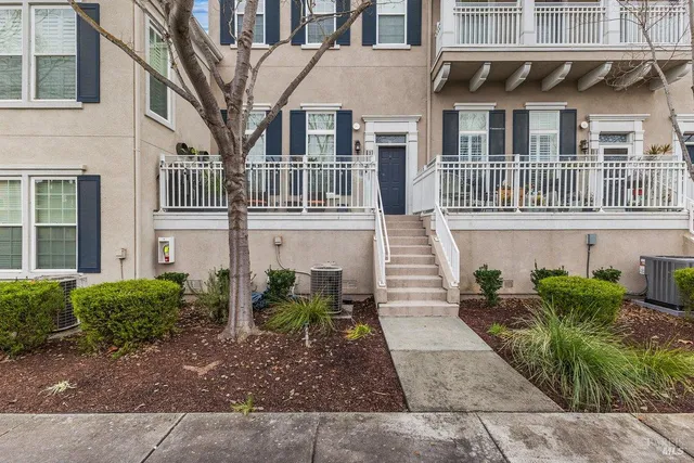 a front view of a house with a parking space and a window