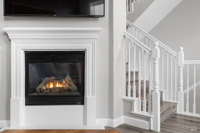 a living room with a fireplace and a flat screen tv