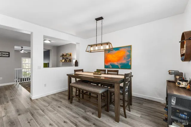 a view of a dining room with furniture wooden floor and a chandelier