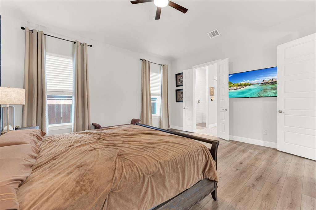 6404 Trezevant Street Rowlett, TX 75089 - Photo 18 of 30 a bed sitting in a spacious bedroom next to a window
