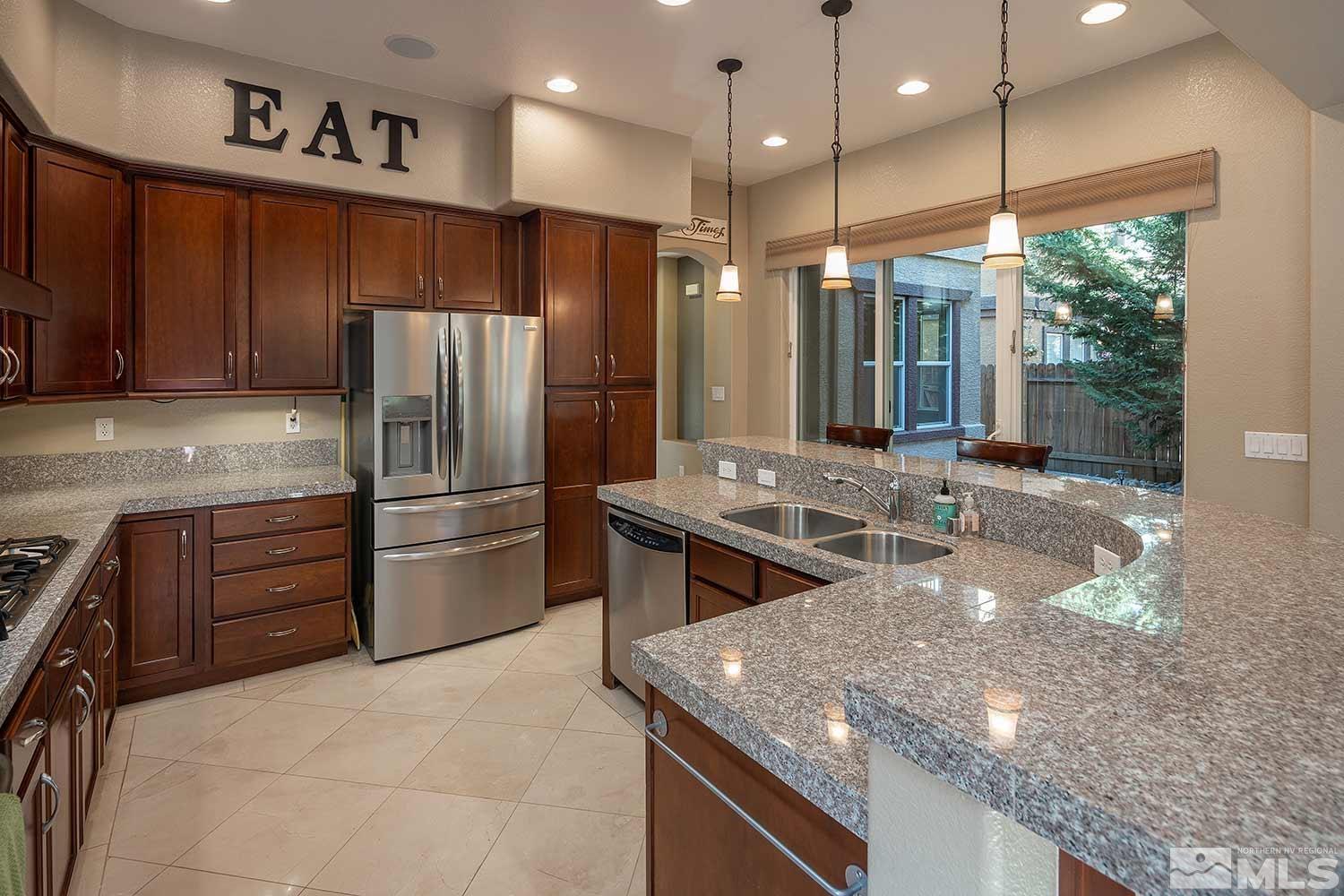 1861 Braemore Drive Reno, NV 89521 - Photo 13 of 40 a kitchen with stainless steel appliances granite countertop a refrigerator and a sink