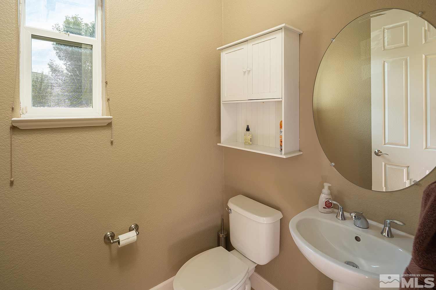 1861 Braemore Drive Reno, NV 89521 - Photo 17 of 40 a white toilet sitting next to a bathroom sink