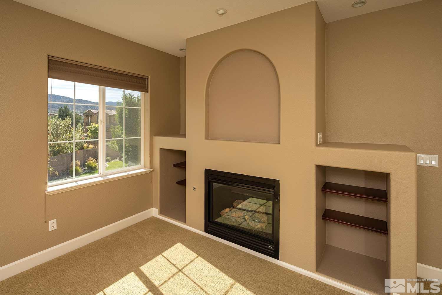 1861 Braemore Drive Reno, NV 89521 - Photo 33 of 40 a living room with fireplace and a window