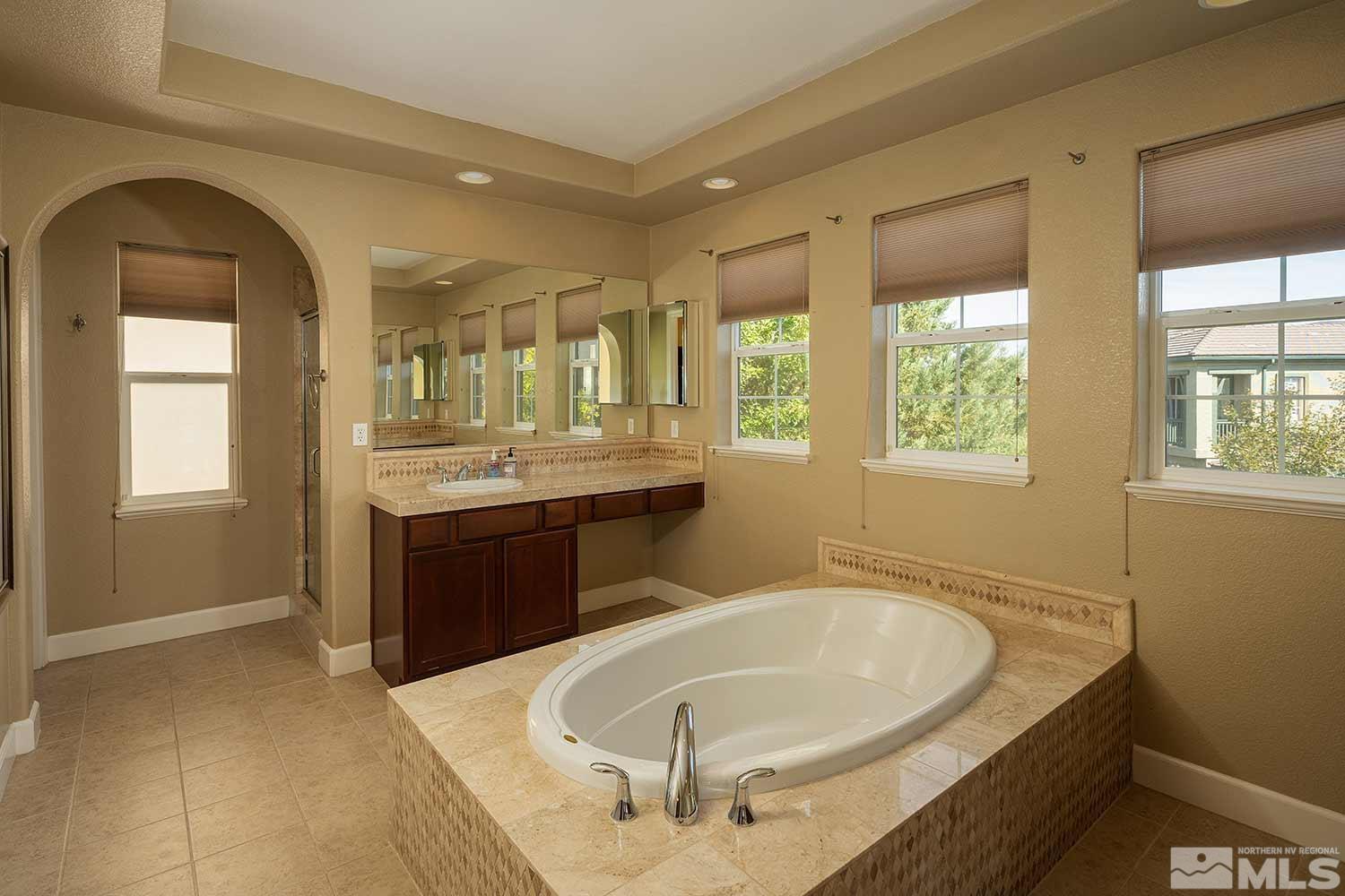 1861 Braemore Drive Reno, NV 89521 - Photo 37 of 40 a spacious bathroom with a tub a sink and mirror