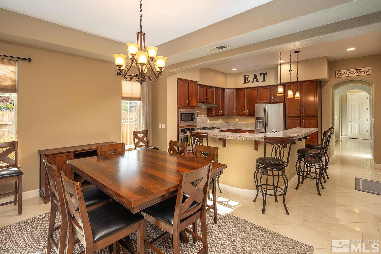 1861 Braemore Drive Reno, NV 89521 - Photo 7 of 40 a view of a dining room with furniture and a chandelier