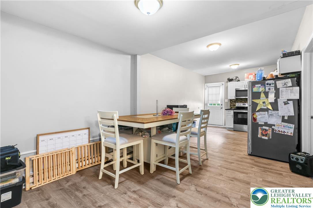 12 South Front Street Coplay, PA 18037 - Photo 25 of 41 This inviting dining area seamlessly connects to a modern kitchen, perfect for casual meals and entertaining.