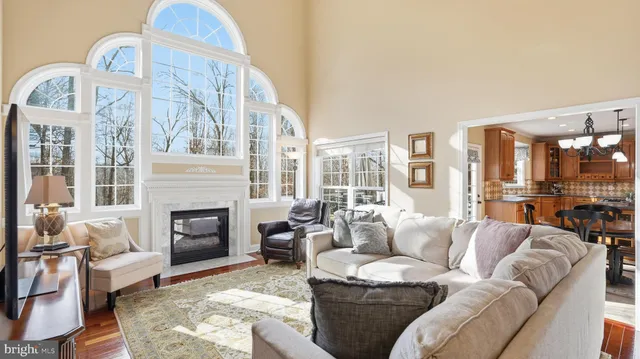 a living room with furniture fireplace and a large window