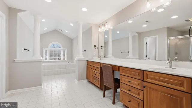 a spacious bathroom with a granite countertop sink mirror and double