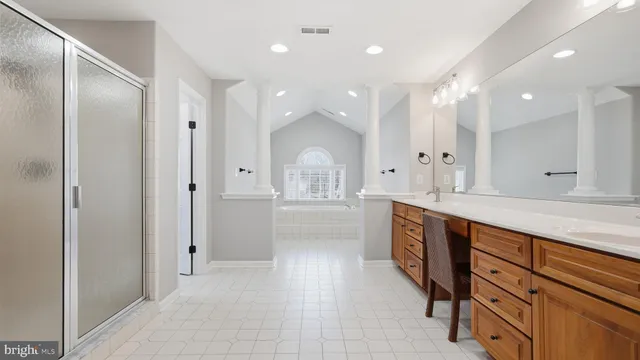 a large bathroom with a granite countertop sink mirror and a shower