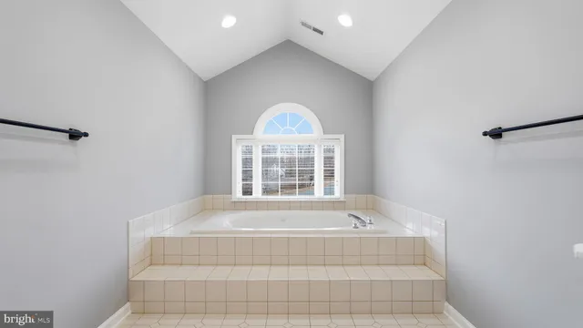 a bathroom with a bathtub and a window