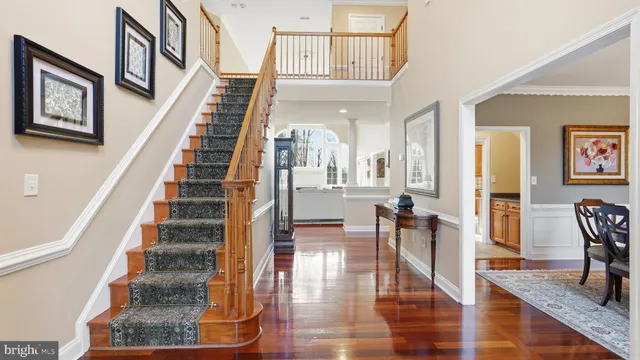 a view of entryway and hall with wooden floor