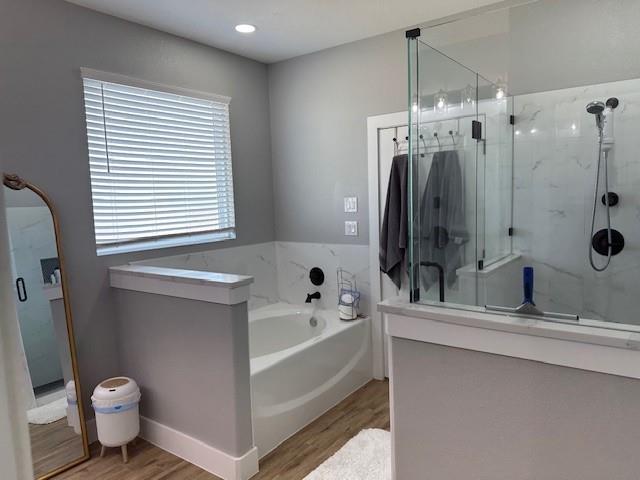 351 Mesa Ridge Decatur, TX 76234 - Photo 14 of 29 Bathroom featuring a garden tub, a marble finish shower, and wood finished floors