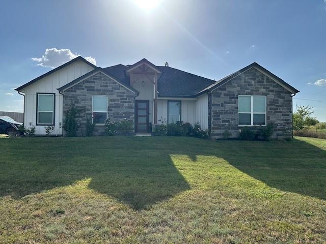 351 Mesa Ridge Decatur, TX 76234 - Photo 26 of 29 Ranch-style house featuring stone siding, board and batten siding, and a front lawn