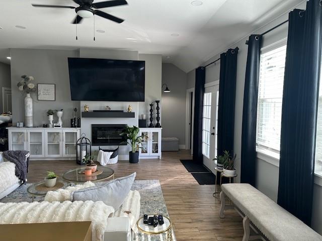 351 Mesa Ridge Decatur, TX 76234 - Photo 7 of 29 Living area featuring vaulted ceiling, a ceiling fan, a glass covered fireplace, and wood finished floors